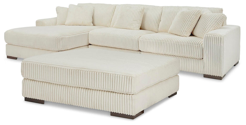 Ashley Furniture Lindyn living room set featuring a sofa and matching chairs in a modern design, with neutral upholstery and wooden legs.