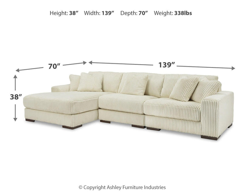 Ashley Furniture Lindyn living room set with a sofa and armchair featuring neutral upholstery and wooden legs.