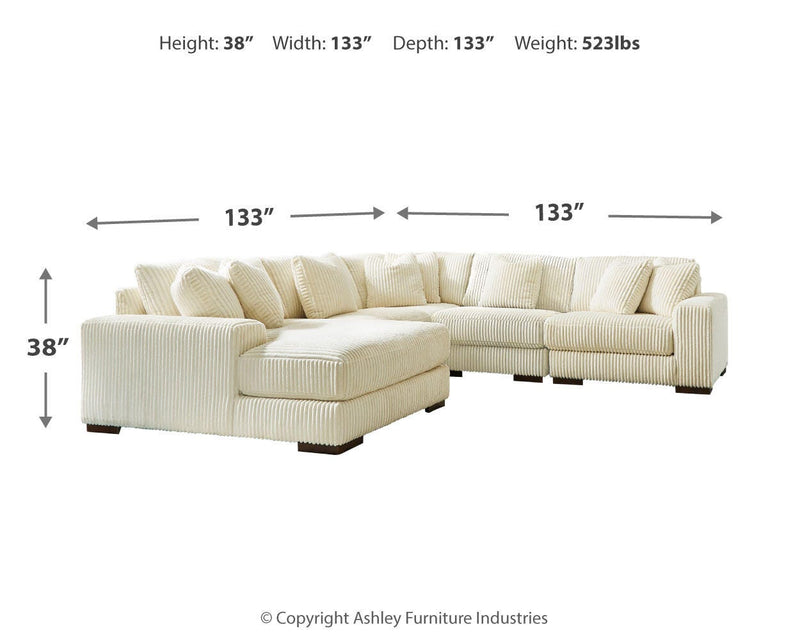 Ashley Furniture Lindyn living room set featuring a sofa and armchair with neutral upholstery and modern design.
