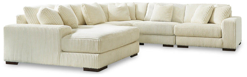 Ashley Furniture Lindyn sectional with chaise, featuring plush fabric, modern design, and multiple seating areas.