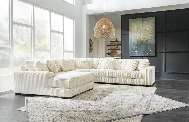 Ashley Furniture Lindyn living room set with sofa and loveseat featuring neutral fabric and modern design.