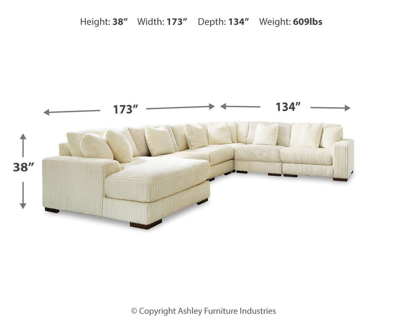 Ashley Furniture Lindyn sectional with chaise showing plush fabric, modern design, and spacious seating arrangement.