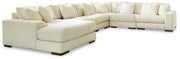 Ashley Furniture Lindyn sectional with chaise, featuring plush cushions and modern design in a neutral fabric.