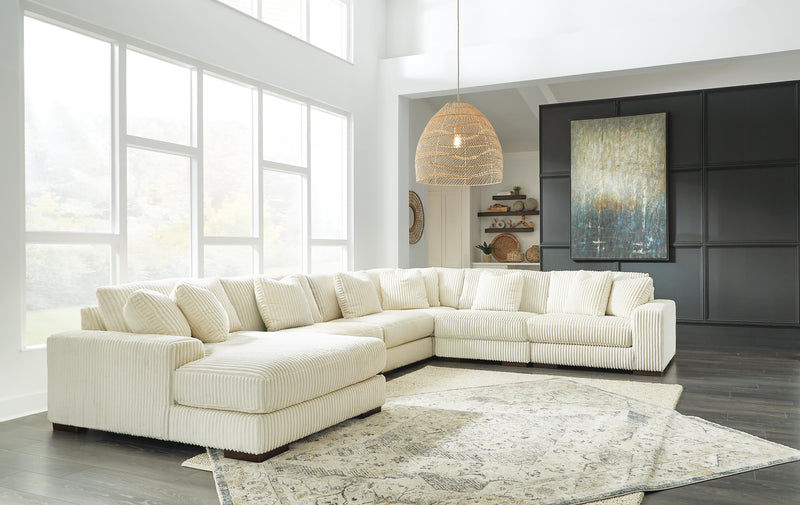 Ashley Furniture Lindyn sectional with chaise, showing plush fabric upholstery and modern design in a spacious living room setting.