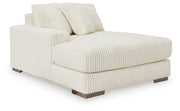 Ashley Furniture Lindyn sectional with chaise, showing a modern fabric sofa with a spacious chaise lounge in a living room setting.