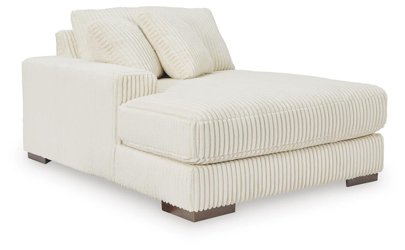 Ashley Furniture Lindyn sectional with chaise, showing a modern fabric sofa with a spacious chaise lounge in a living room setting.