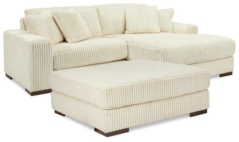 Ashley Furniture Lindyn living room set showing a modern sofa and loveseat with neutral upholstery and wooden legs.
