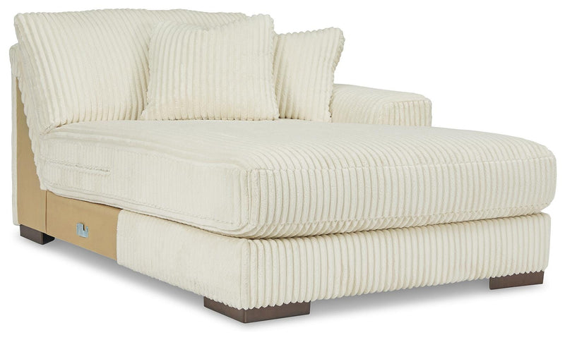 Ashley Furniture Lindyn sectional with chaise, showing a modern fabric sofa with a spacious chaise lounge in a stylish living room setting.