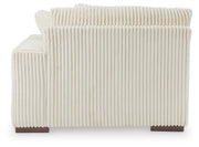 Ashley Furniture Lindyn sectional with chaise featuring plush cushions and modern design, shown from the back in the image.
