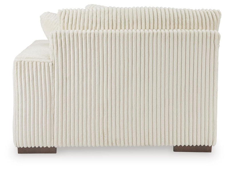 Ashley Furniture Lindyn sectional with chaise featuring plush cushions and modern design, shown from the back in the image.
