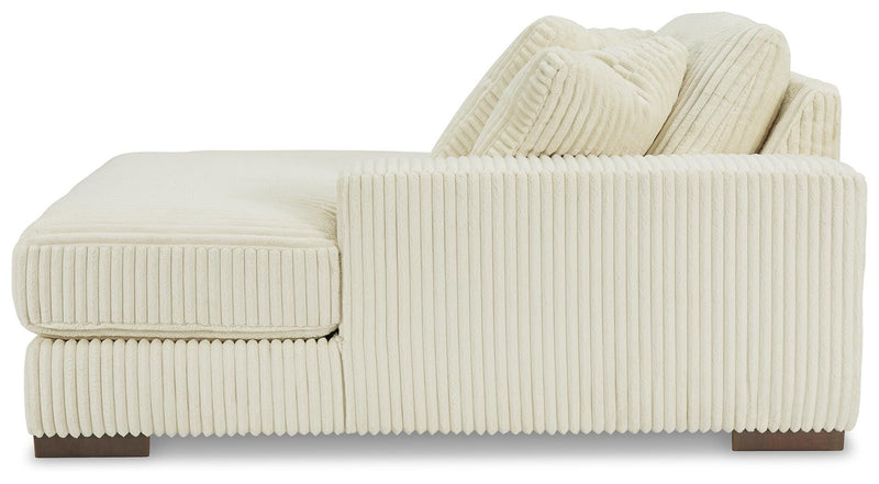 Ashley Furniture Lindyn sectional with chaise, featuring plush upholstery and modern design, shown from a side view.