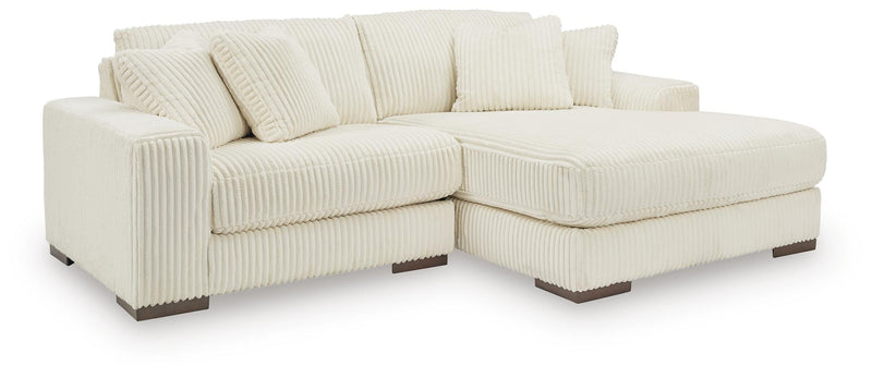 Ashley Furniture Lindyn sectional with chaise, featuring plush cushions and contemporary design in a neutral fabric.