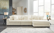 Ashley Furniture Lindyn living room set with sofa, loveseat, and armchair in neutral fabric, arranged in a modern living space.