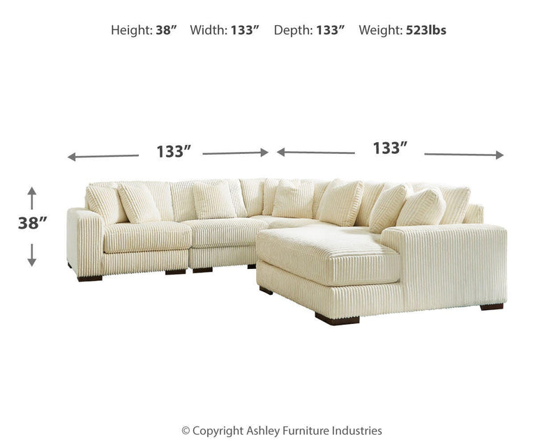 Ashley Furniture Lindyn living room set with beige fabric sofa and matching armchair in a modern home interior.