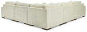 Ashley Furniture Lindyn sectional with plush fabric, featuring seat cushions, back pillows, and a modern design in a neutral tone.