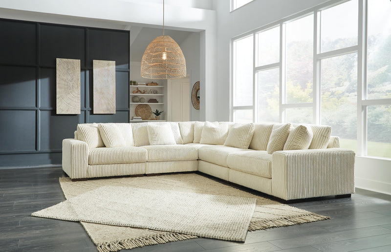 Ashley Furniture Lindyn sectional sofa with plush cushions and neutral fabric, shown in a modern living room setting.