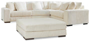 Ashley Furniture Lindyn living room set with sofa, loveseat, and armchair in neutral fabric, arranged in a modern living space.