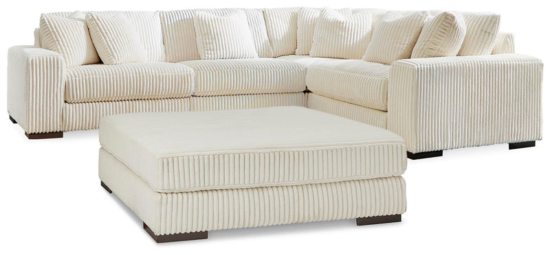 Ashley Furniture Lindyn living room set with sofa, loveseat, and armchair in neutral fabric, arranged in a modern living space.