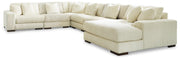 Ashley Furniture Lindyn sectional with chaise, showing a modern fabric sofa with a spacious chaise lounge in a living room setting.