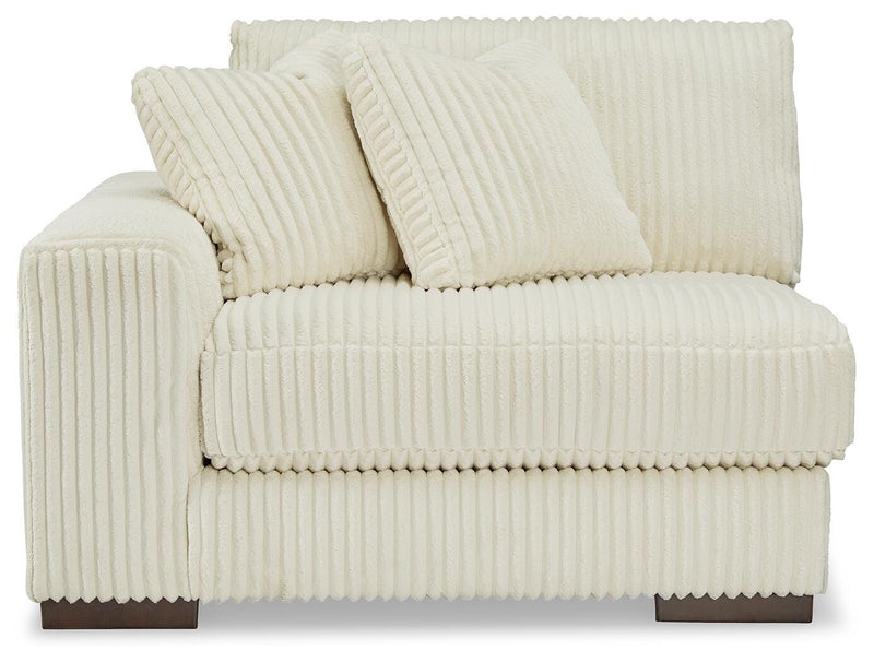 Ashley Furniture Lindyn sectional with chaise, view of the beige fabric sofa and chaise lounge from the front.