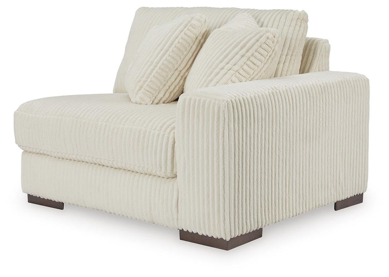 Ashley Furniture Lindyn sectional with chaise, showing a modern fabric sofa with a spacious chaise lounge in a living room setting.