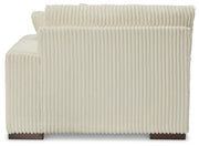 Ashley Furniture Lindyn sectional with chaise, showing plush fabric and modern design, with a focus on the back and side view.