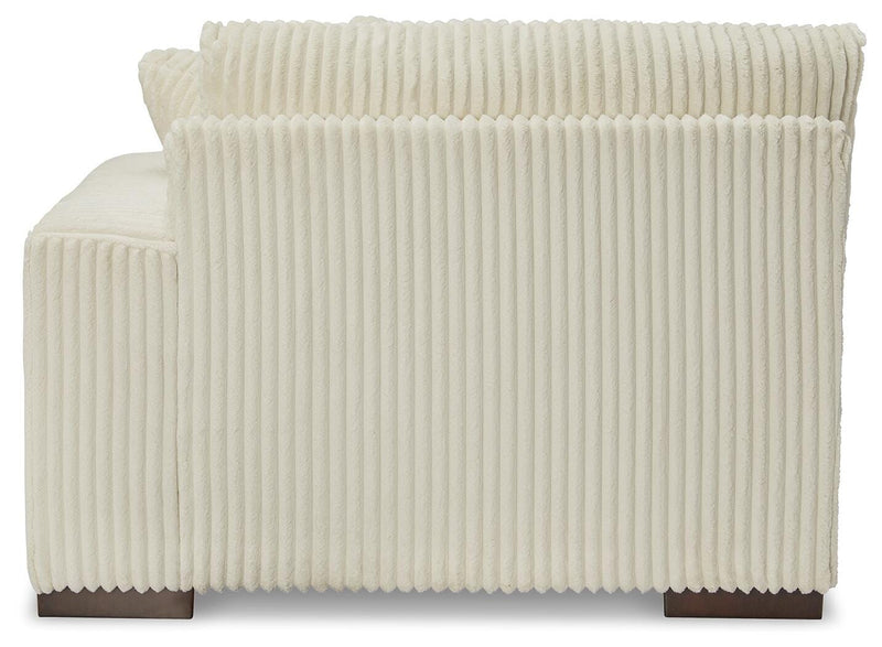 Ashley Furniture Lindyn sectional with chaise, showing plush fabric and modern design, with a focus on the back and side view.