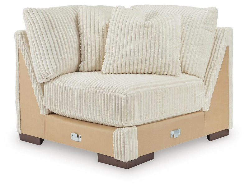 Ashley Furniture Lindyn sectional with chaise, showing plush beige fabric and modern design from a head-on view.