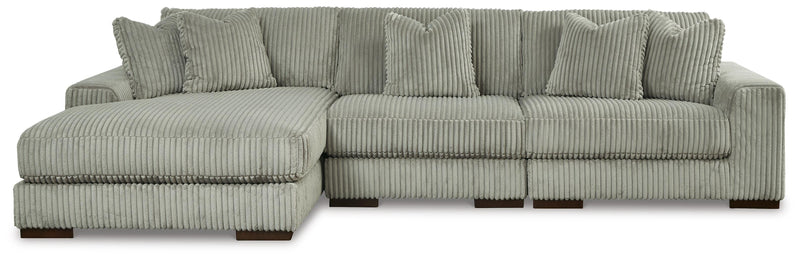 Ashley Furniture Lindyn sectional with chaise in neutral fabric, featuring plush cushions and a modern design.