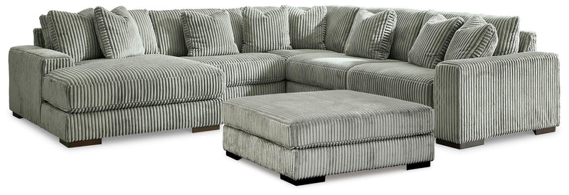 Ashley Furniture Lindyn living room set includes a sofa, loveseat, and coffee table with neutral fabric upholstery.