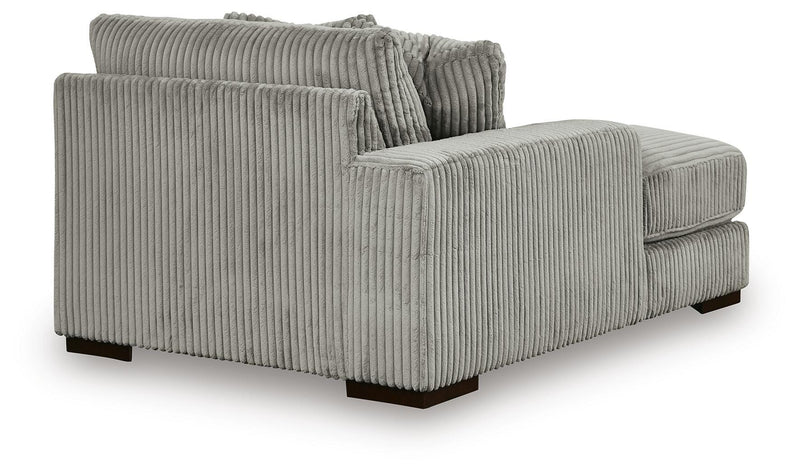 Ashley Furniture Lindyn sectional with double chaise, featuring plush cushions and modern design in a spacious living room setting.