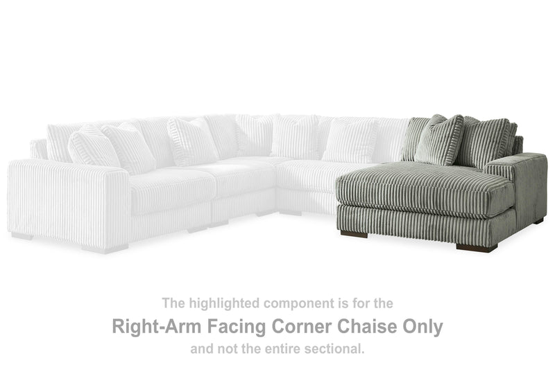 Ashley Furniture Lindyn sectional with chaise, beige fabric sofa featuring plush cushions and wide armrests.