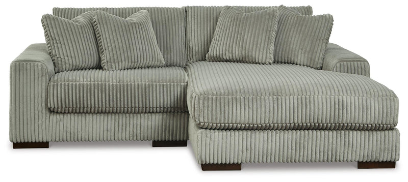 Ashley Furniture Lindyn sectional with chaise, featuring plush fabric upholstery and modern design, shown in a spacious living room.