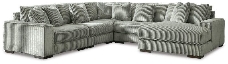 Ashley Furniture Lindyn sectional with chaise, showing plush fabric upholstery and modern design in a spacious living room setting.