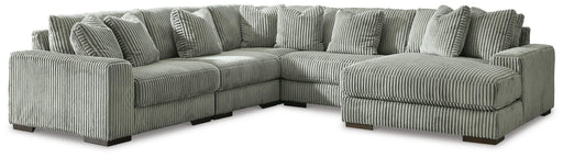 Ashley Furniture Lindyn living room set featuring a sofa and armchair with neutral fabric upholstery and modern design.