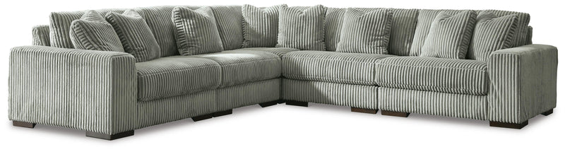 Ashley Furniture Lindyn sectional sofa with plush cushions and neutral fabric, shown in a modern living room setting