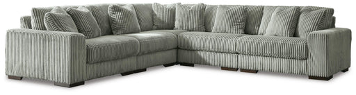 Ashley Furniture Lindyn sectional sofa with plush cushions and neutral fabric, shown in a modern living room setting