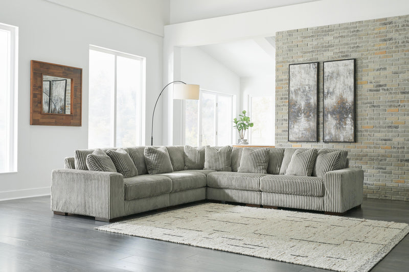 Ashley Furniture Lindyn sectional sofa with plush cushions and neutral fabric, shown in a modern living room setting.