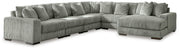 Ashley Furniture Lindyn sectional with chaise, showing beige fabric upholstery and plush cushions in a modern living room setting.