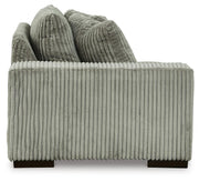 Ashley Furniture Lindyn sectional with chaise showing beige fabric upholstery and modern design in a living room setting.