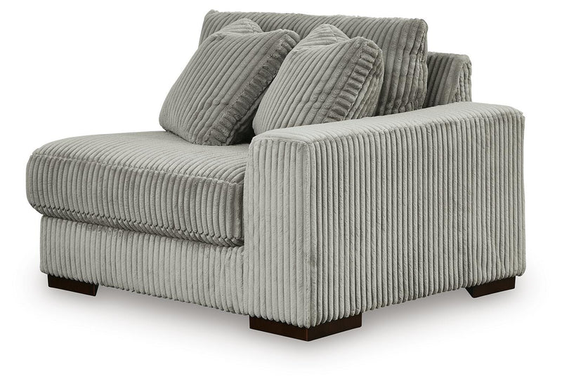 Ashley Furniture Lindyn sectional with chaise, featuring plush fabric, modern design, and multiple seating areas, shown from an angled view.
