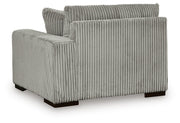 Ashley Furniture Lindyn sectional with chaise, showing plush fabric upholstery and contemporary design in a spacious living room setting.