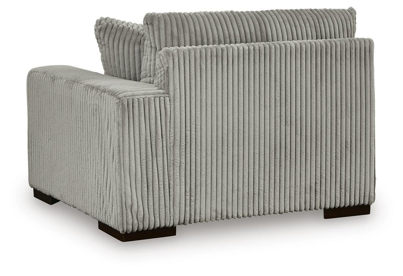 Ashley Furniture Lindyn sectional with chaise, showing plush fabric upholstery and contemporary design in a spacious living room setting.