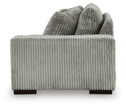 Ashley Furniture Lindyn sectional with chaise, featuring plush fabric and modern design, shown with a side view.