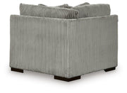 Ashley Furniture Lindyn sectional with chaise, showing the back view of the beige fabric sofa with plush cushions and modern design.