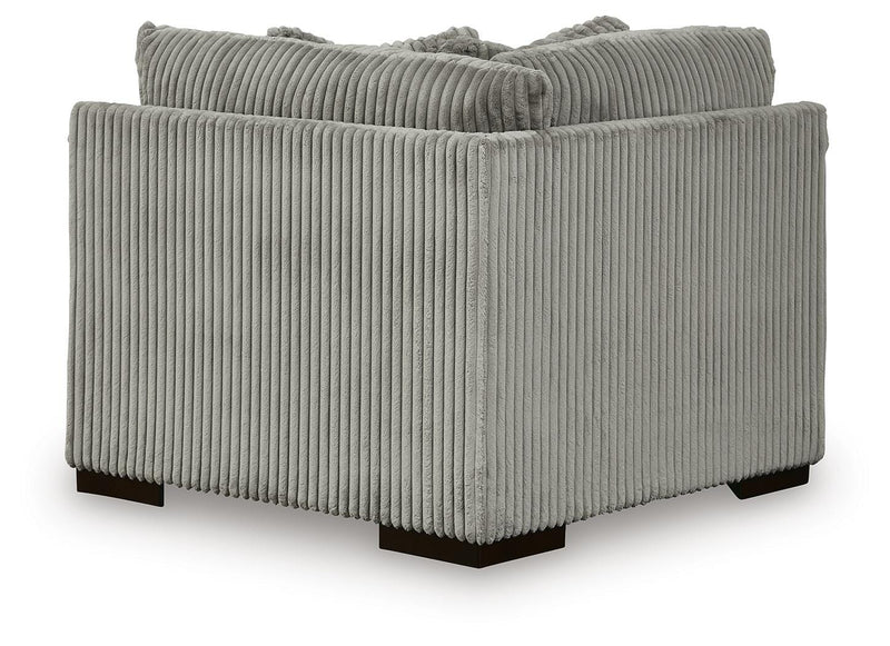 Ashley Furniture Lindyn sectional with chaise, showing the back view of the beige fabric sofa with plush cushions and modern design.