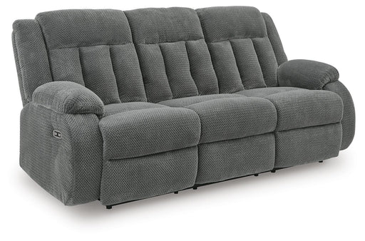 Ashley Furniture observation power reclining sofa with integrated drop-down table, shown from an angled side view.