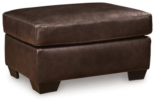 Ashley Furniture Santorine Ottoman with neutral fabric and wooden legs, shown from an angled view.