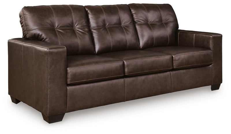 Ashley Furniture Santorine Sofa Sleeper in a stylish fabric, shown from an angled side view with cushions and wooden legs.