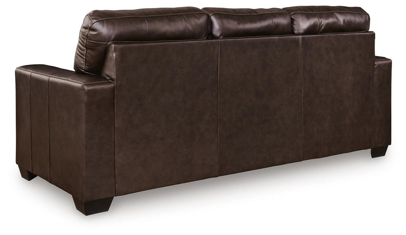 Ashley Furniture Santorine Sleeper Sofa showing the back view with fabric upholstery and wooden legs.